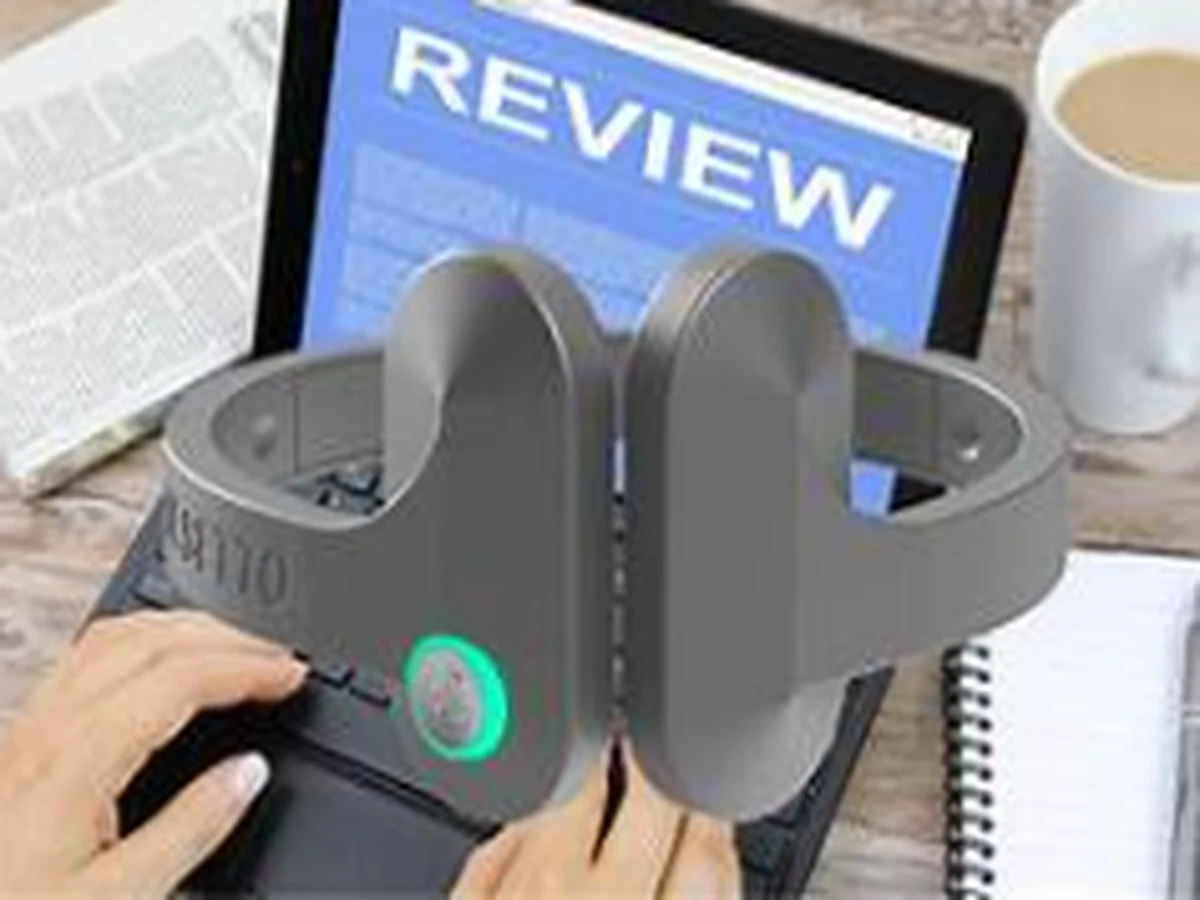 Neck-worn wearable device placed on a desk near a laptop displaying a review page